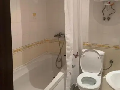 a bathroom with a toilet and a tub and a sink at Sozopol Dreams - Apartment 1 in Sozopol