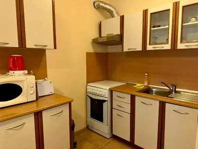 a small kitchen with a microwave and a sink at Sozopol Dreams - Apartment 1 in Sozopol