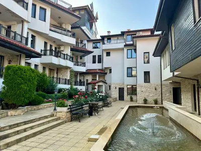 a courtyard with a pond in front of a building at Sozopol Dreams - Apartment 1 in Sozopol