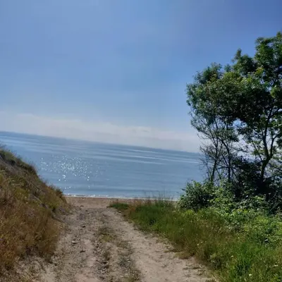 a dirt road next to the ocean on a clear day at Sun Holidays Byala in Byala