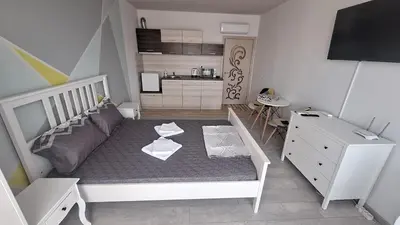 a small room with a bed and a kitchen at Beachfront one bedroom apartment DIAMOND BEACH Burgas Sarafovo Студио в Diamond beach Сарафово in Burgas City