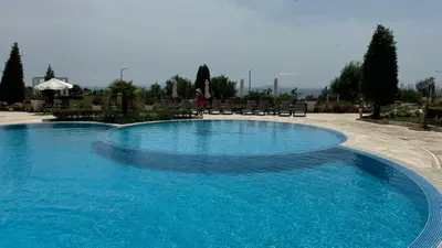 a large pool with blue water in a resort at Beachfront one bedroom apartment DIAMOND BEACH Burgas Sarafovo Студио в Diamond beach Сарафово in Burgas City