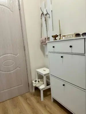 a bedroom with a white dresser and a closet at Triumph apartment in Burgas City