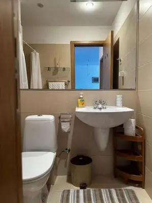 a bathroom with a toilet and a sink at Apartment in Paradise View complex in Sozopol