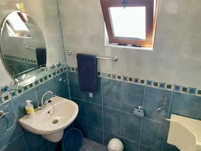 a bathroom with a sink and a mirror at Къща за Гости Чайка in Byala