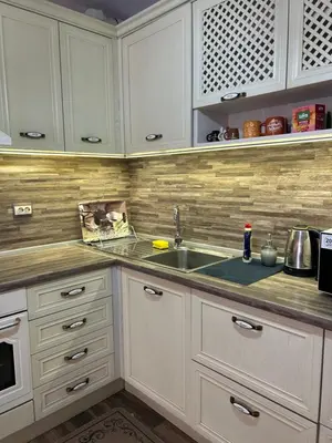 a kitchen with white cabinets and a sink at GREAT Apartament in Burgas City