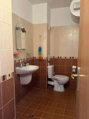 a bathroom with a sink and a toilet and a mirror at апартамент под наем виа понтика in Sozopol