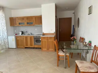 a kitchen with a glass table and a dining room at апартамент под наем виа понтика in Sozopol