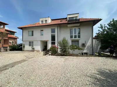 a house on a gravel road with a building at апартамент под наем виа понтика in Sozopol