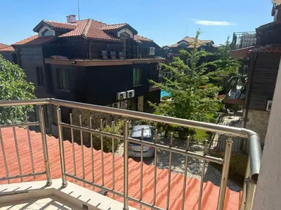 a view of a balcony of a house with a car at апартамент под наем виа понтика in Sozopol