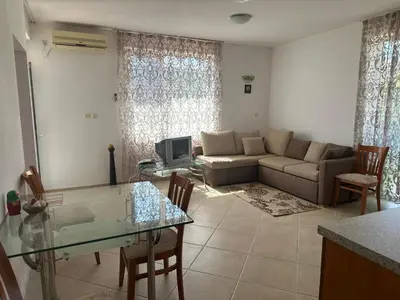 a living room with a couch and a table at апартамент под наем виа понтика in Sozopol