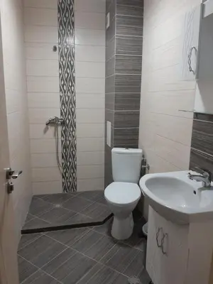 a bathroom with a toilet and a sink at студио Орхидея Сарафово лукс с изглед към морето in Burgas City