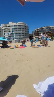 a group of people on a beach with buildings at Studio Dream Мечта in Sunny Beach