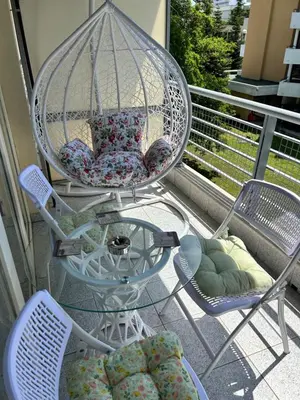 a porch with two chairs and a bird cage at Studio Dream Мечта in Sunny Beach