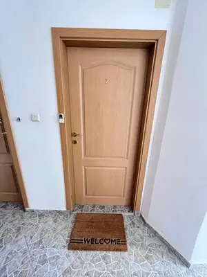 a door in a room with a welcome mat at Apartment Divna in Sozopol