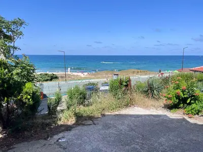 a view of a beach with the ocean in the background at Apartment Divna in Sozopol