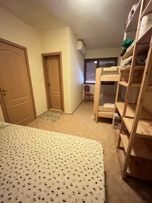 a room with a bed and bunk beds in it at Apartment Divna in Sozopol