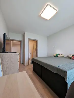 a bedroom with a bed and a table in a room at Foros Apartment in Kraymorie