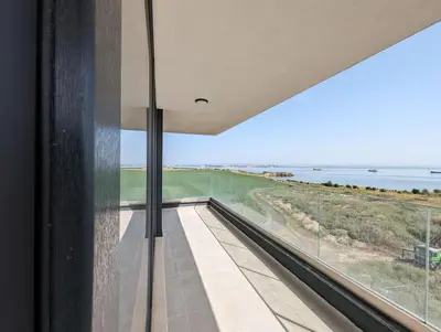 a room with a large window looking out at the ocean at Foros Apartment in Kraymorie