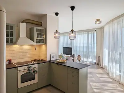 a kitchen with a stove and a counter top at Foros Apartment in Kraymorie