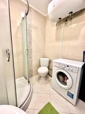 a bathroom with a washing machine and a toilet at Mint Casa Rossa in Sunny Beach
