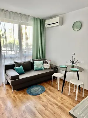 a living room with a couch and a table at Mint Casa Rossa in Sunny Beach