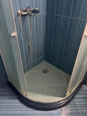 a shower with a shower head in a bathroom at На гости в Созопол in Sozopol