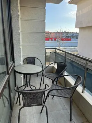 three chairs and a table on a balcony with a view at На гости в Созопол in Sozopol
