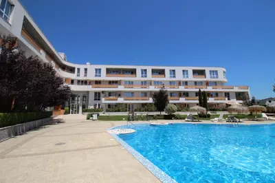a hotel with a swimming pool in front of a building at Doris Beach apartment D06 in Burgas City