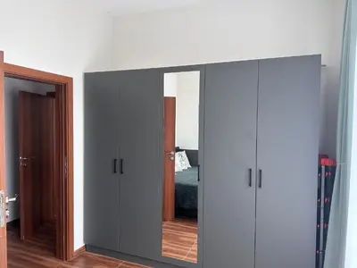 a mirrored cabinet in a bedroom with a mirror at Doris Beach apartment D06 in Burgas City