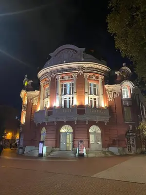 a large building with lights on it at night at Varna Central Sea Apartment in Varna City