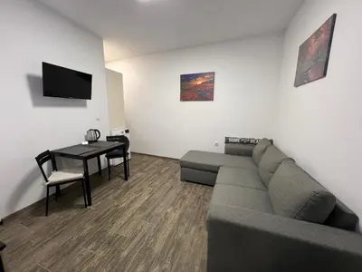 a living room with a couch and a table at Varna Central Sea Studio in Varna City
