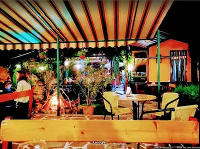 a patio with a table and chairs and an umbrella at Nice 2 Bedrooms With Ocean View In Byala in Byala
