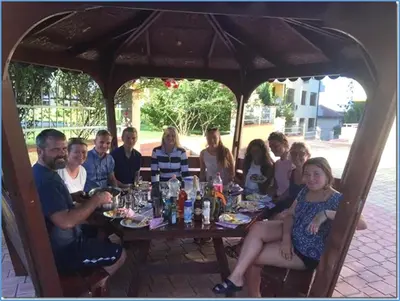 a group of people sitting around a table at Nice 2 Bedrooms With Ocean View In Byala in Byala