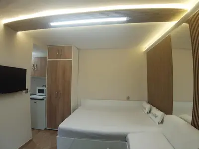 a small room with a bed and a couch at Apartment TINA in Varna City