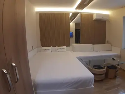 a bedroom with two beds with white sheets at Apartment TINA in Varna City