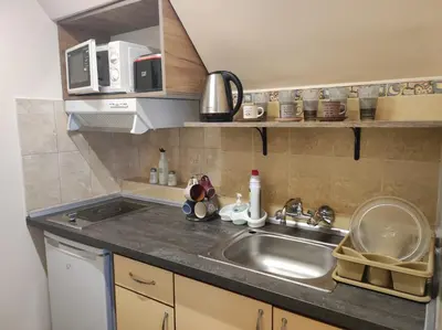 a kitchen with a sink and a counter top at Апартамент с уникална панорама Несебър in Nesebar