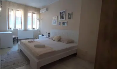 a bedroom with a bed with two towels on it at Aпартамент Жужа in Nesebar