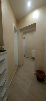 an empty room with a kitchen and a large garage at Aпартамент Жужа in Nesebar