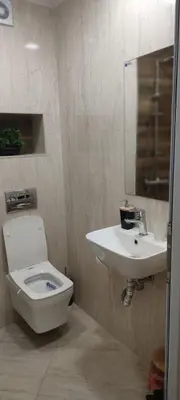 a bathroom with a toilet and a sink at Aпартамент Жужа in Nesebar