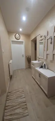 a bathroom with a sink and a clock on the wall at Aпартамент Жужа in Nesebar