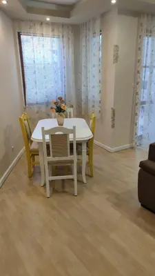 a white table and chairs in a living room at Aпартамент Жужа in Nesebar