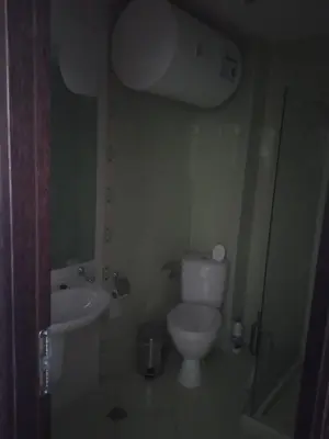 a small bathroom with a toilet and a sink at Piękny apartament nad morzem czarnym in Aheloy