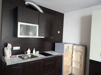 a kitchen with a sink and a refrigerator at Piękny apartament nad morzem czarnym in Aheloy