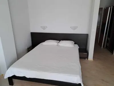 a bedroom with a bed with white sheets and pillows at Wspaniały apartament w kompleksie Galateya in Sveti Vlas