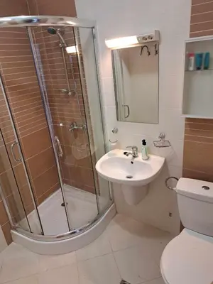 a bathroom with a shower and a sink and a toilet at Wspaniały apartament w kompleksie Galateya in Sveti Vlas