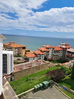 a group of apartment buildings with the ocean in the background at Wspaniały apartament w kompleksie Galateya in Sveti Vlas