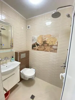 a bathroom with a toilet and a sink at Guest House Ropotamo in Primorsko