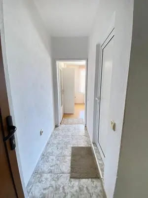 an empty hallway with a door and a tile floor at Guest House Ropotamo in Primorsko