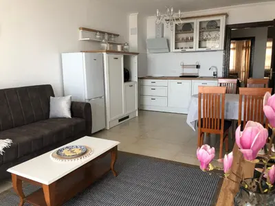 a living room with a couch and a table at 2 bedroom apartment Sveti Vlas with 2 balconies and sea views in Sveti Vlas